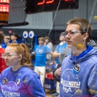 Two students drive their robot
